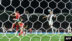 Germany's forward #11 Alexandra Popp (R) heads the ball and scores her team's first goal during the Australia and New Zealand 2023 Women's World Cup Group H football match between Germany and Morocco at Melbourne Rectangular Stadium in Melbourne, July 24, 2023.