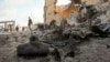 A Somali soldier observes the scene of a car bomb attack in the capital Mogadishu, Somalia, June 21, 2015. 