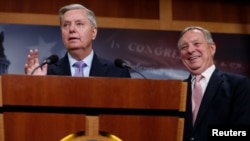 U.S. Senator Lindsey Graham (R-SC), flanked by Senator Dick Durbin (D-IL), right, talks about possible legislation for so-called "dreamer" immigrant children during a news conference at the U.S. Capitol, July 20, 2017.