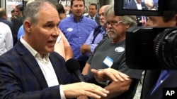 EPA Administrator Scott Pruitt talks to a reporter after speaking at Whayne Supply in Hazard, Kentucky, Oct. 9, 2017. Pruitt says the Trump administration will abandon the Obama-era clean power plan aimed at reducing global warming.