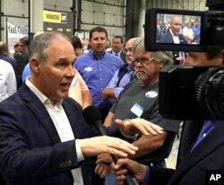 FILE - EPA Administrator Scott Pruitt talks to a reporter after speaking at Whayne Supply in Hazard, Kentucky, Oct. 9, 2017. Pruitt says the Trump administration will abandon the Obama-era Clean Power Plan, aimed at reducing global warming.