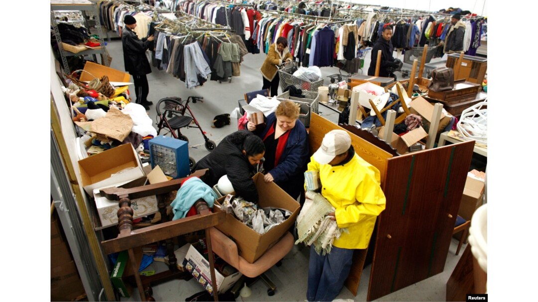 FILE - People look for clothes at the Capuchin Soup Kitchen service center in Detroit, where hundreds of people receive food and supplies every day.