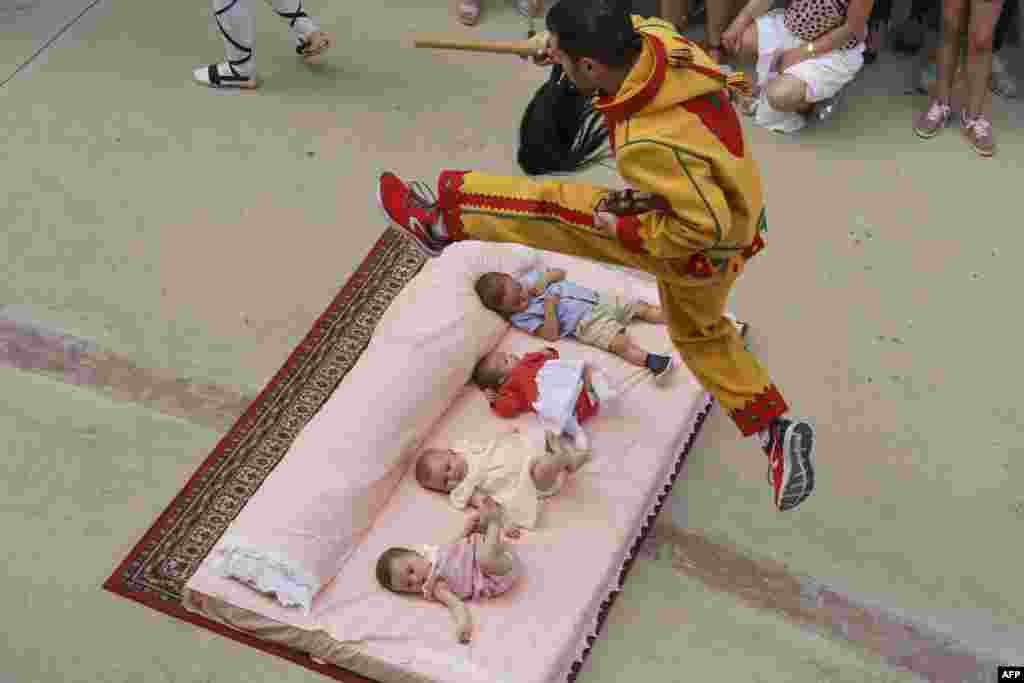 The &quot;Colacho&quot;, a character that represents the devil, jumps over babies lying on a mattress in the street during &#39;El Salto del Colacho&#39; (The Devil&#39;s Jump) festival, in the village of Castrillo de Murcia, near Burgos, Spain, June 23, 2019.