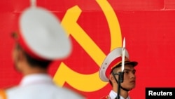 Military soldiers stand guard in front of the symbol of Vietnam's Communist Party during a ceremony to mark the 85th anniversary of its foundation in Hanoi February 2, 2015. Vietnam on Monday celebrates the anniversary of its ruling party, which the late 