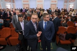 Members of Jehovah's Witnesses wait in a court room in Moscow, Russia, April 20, 2017. The Russian Supreme Court ruled that the Jehovah's Witnesses are an "extremist" group.