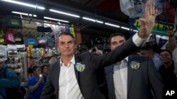 National Social Liberal Party presidential candidate Jair Bolsonaro greets people as he campaigns at Madureira market in Rio de Janeiro, Brazil, Aug. 27, 2018. Brazil will hold general elections on Oct. 7.
