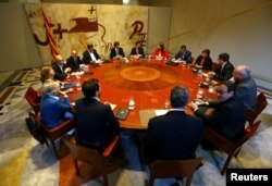 Catalan President Carles Puigdemont presides over a cabinet meeting at the regional government headquarters, the Generalitat, in Barcelona, Oct. 10, 2017.