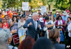 FILE - House Minority Whip Steny Hoyer, D-Md., center, speaks to immigrant rights supporters at the U.S. Capitol in Washington, Sept. 26, 2017.