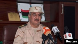 FILE - General Khalifa Haftar speaks during a news conference in Al Marj, east of Benghazi, Libya, June 4, 2014. Hafter's forces say they have pounded Islamist militia fighters who captured key oil ports in the country.