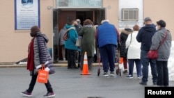 People wait in line to receive Pfizer's coronavirus disease (COVID-19) vaccine at a pop-up community vaccination center at the Gateway World Christian Center in Valley Stream, New York, U.S., February 23, 2021.