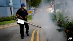 A pest control worker fumigates drains at a local housing development where Zika infections were reported in Singapore, Sept. 1, 2016.