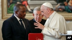 FILE - Pope Francis talks with Congo President Joseph Kabila during a private audience in the pontiff's studio, at the Vatican, Sept. 26, 2016. 