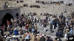Mine workers and residents gather outside a coal mine after a explosion in Sorange near Quetta, Pakistan, March 20, 2011