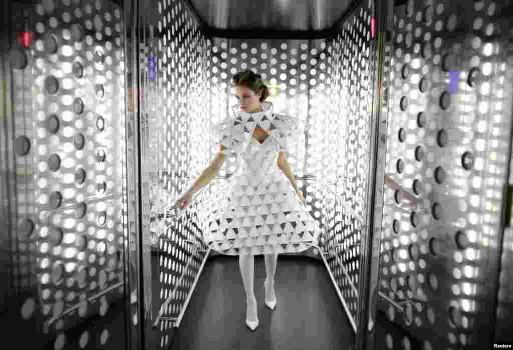 Spanish model, Raquel Bonilla, 22, poses inside an elevator as she wears a creation by Myriam Hurtado during an urban photo shoot, part of the Andalucia de Moda (Andalusia Fashion) in Seville, southern Spain. 