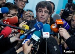FILE - Fugitive Catalan leader Carles Puigdemont addresses the media in Brussels, Belgium, Jan. 24, 2018.