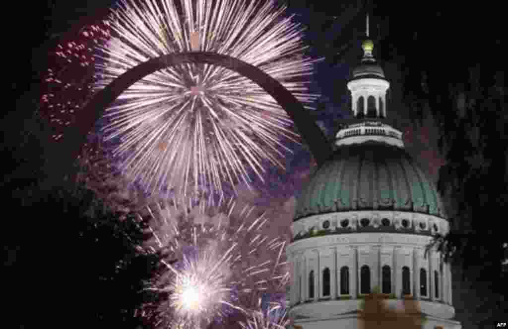 Fireworks light up the night sky behind the Gateway Arch and the Old Courthouse Monday, July 4, 2011, in St. Louis. (AP Photo/Jeff Roberson)