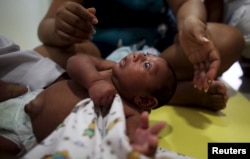 Gustavo Henrique who is 2 months old and born with microcephaly, reacts to stimulus during an evaluation session with a physiotherapist at the Altino Ventura rehabilitation center in Recife, Brazil, Feb. 11, 2016.