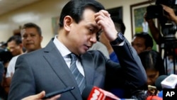 Philippine opposition Sen. Antonio Trillanes gestures as he talks to the media outside his office in the Philippine Senate after posting bail at a regional trial court following an arrest warrant issued, Sept. 25, 2018 in suburban Pasay city, south of Manila.
