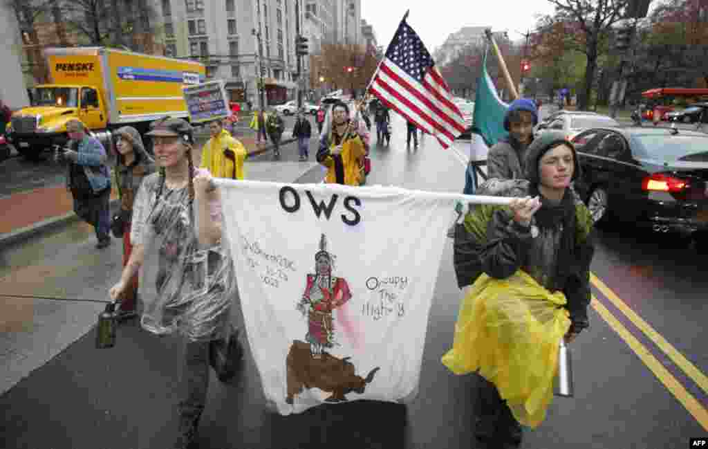 Marchers from New York to Washington chant as they walk along K Street northwest in downtown Washington, Tuesday, November 22, 2011, during the Occupy the Highway march from New York to Washington by Occupy Wall Street protestors. (AP Photo/Manuel Balce