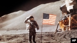 July 30, 1971 NASA photo, Apollo 15 Lunar Module Pilot James B. Irwin salutes while standing beside the fourth American flag planted on the moon. 