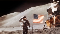 FILE - In this July 30, 1971 NASA photo, Apollo 15 Lunar Module Pilot James B. Irwin salutes while standing beside the fourth American flag planted on the moon. On March 26, 2019, Vice President Mike Pence called for landing astronauts on the moon within