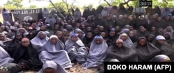 A video from Boko Haram claims to show the abducted Nigerian schoolgirls wearing full-length hijabs and praying in an undisclosed location in a screengrab taken May 12, 2014.