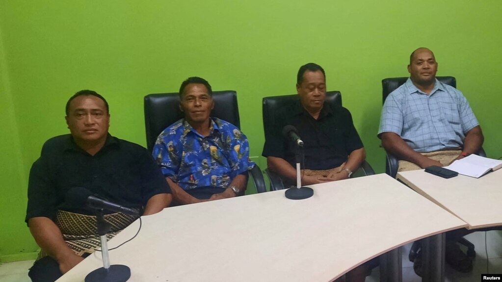 Lisala Folau (wearing blue printed shirt), 2nd L, a Tongan man who says he swam for around 27 hours after getting swept to sea by Saturday's tsunami, January 19, 2022 in this picture obtained from social media. (Marian Kupu/Broadcom Broadcasting FM87.5/via REUTERS)