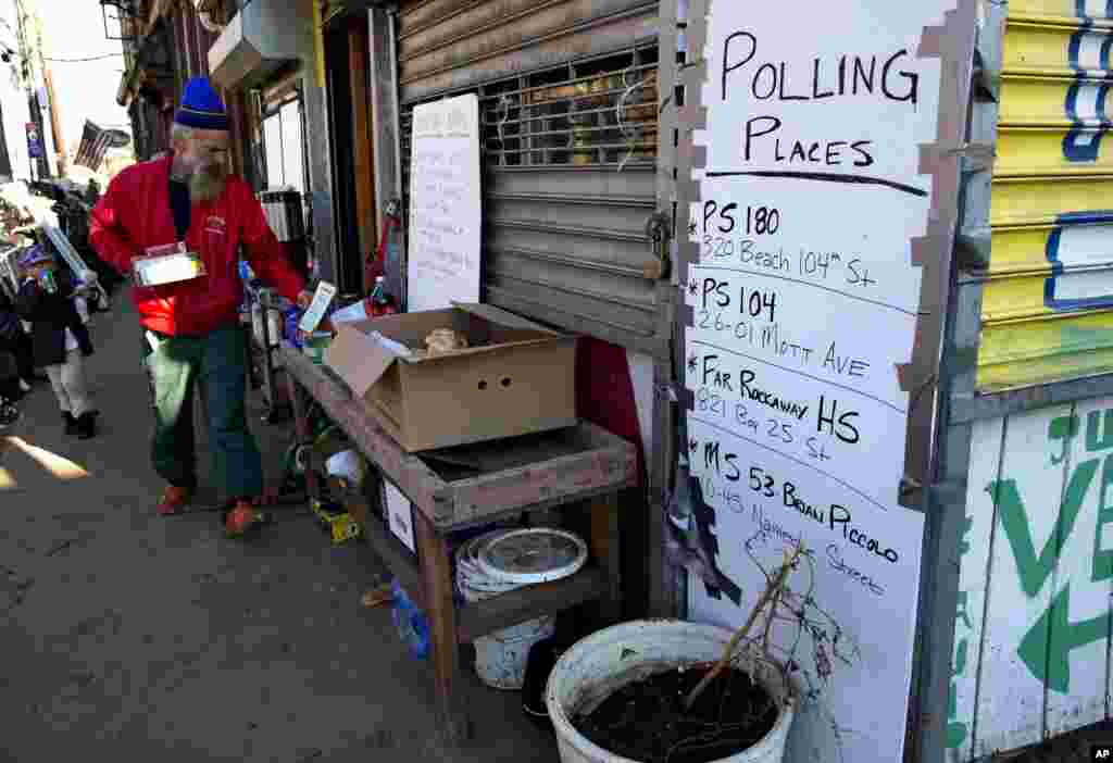 A sign erected by a community group called Rebuild Rockaway shows voting locations in the Rockaway neighborhoods of the borough of Queens, New York, Monday, Nov. 5, 2012, in the wake of Superstorm Sandy. Election officials are ordering generators, moving