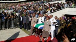 The casket carrying the remains of struggle icon Winnie Madikizela-Mandela arrives at the Orlando Stadium in Soweto, South Africa, Saturday, April 14, 2018. Madikizela-Mandela died on April 2 at the age of 81.