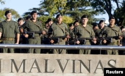 FILE - Officers pay tribute to the Argentine servicemen who died in the1982 Falklands War between Britain and Argentina on the 33rd anniversary of the war over the island chain in Rosario, Argentina, April 2, 2015.