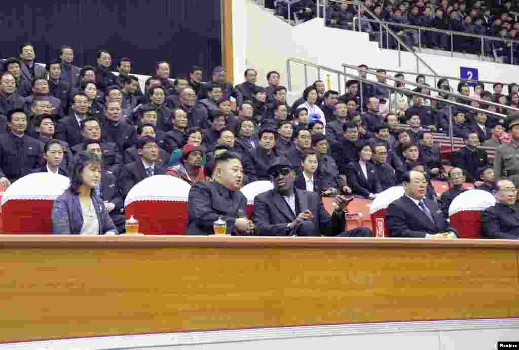 North Korean leader Kim Jong-Un (2nd L), his wife Ri Sol-Ju (L) and former NBA basketball player Dennis Rodman (3rd L) watch an exhibition basketball game in Pyongyang in this undated picture released by North Korea's KCNA news agency on March 1, 2013. KC