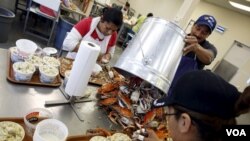 Mexican workers, on the U.S. H2B visa program for seasonal guest workers, process crabs at the A.E. Phillips & Son Inc. crab picking house on Hooper's Island in Fishing Creek, Maryland, Aug. 26, 2015.