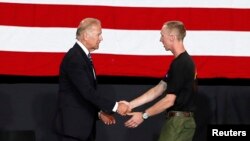 U.S. Vice President Joe Biden (l) shakes hands with surviving Hotshot crew member Brendan McDonough at a memorial service for the fallen members of the Granite Mountain Hotshots, in Prescott Valley, Arizona July 9, 2013. 