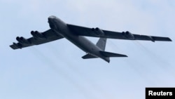 A Boeing B-52 Stratofortress strategic bomber from the United States Air Force (USAF) Andersen Air Force Base in Guam performs a fly-past during an aerial display at the Singapore Airshow in Singapore February 14, 2012. 