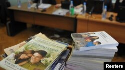 FILE - Stacks of booklets distributed by members of Jehovah's Witnesses are seen during the court session in the Siberian town of Gorno-Altaysk, Dec. 16, 2010. 