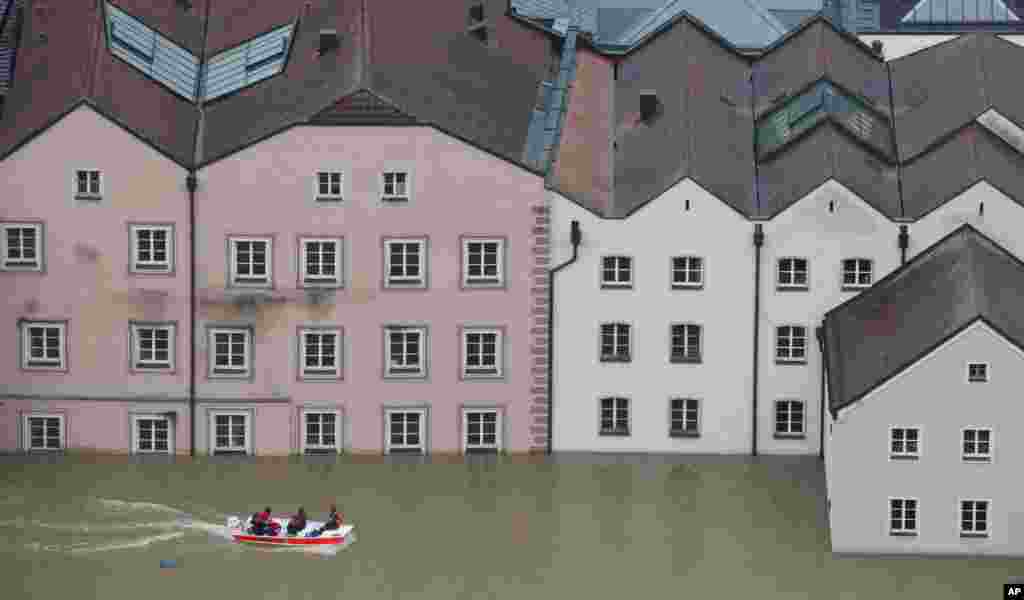 Members of the Red Cross make their way by boats in the flooded street in the center of Passau, southern Germany. Raging waters from three rivers have flooded large parts of the southeast German city following days of heavy rainfall in central Europe.