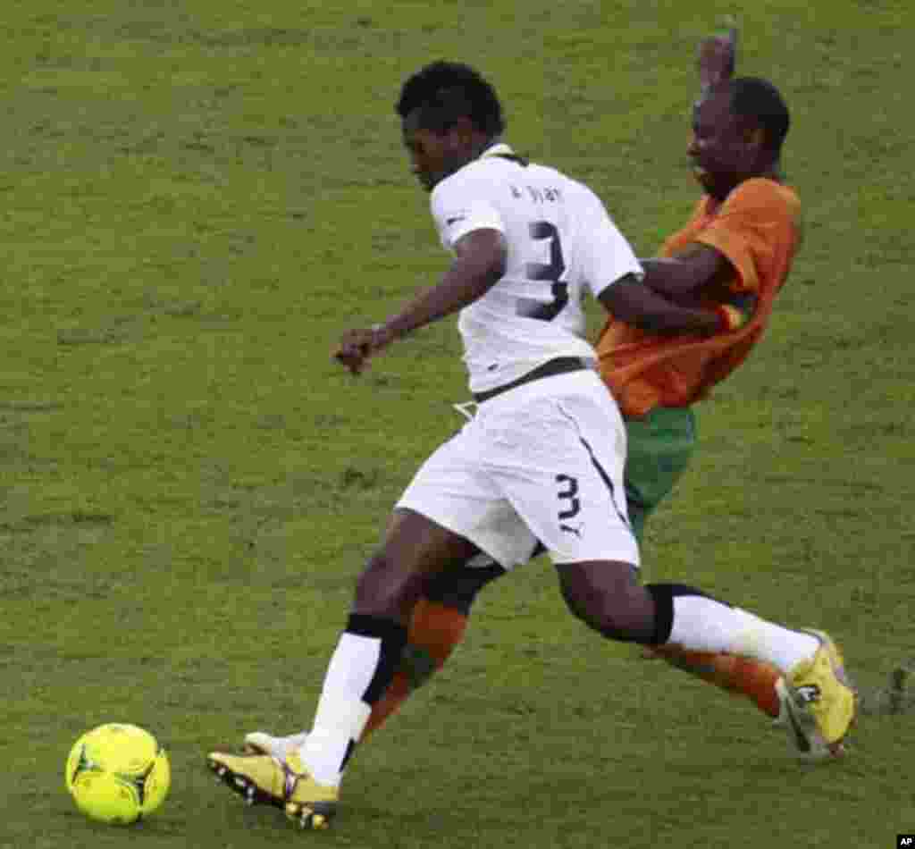 James Chamanga of Zambia (back) fights for the ball with Asamoah Gyan of Ghana during their African Nations Cup semi-final soccer match at Estadio de Bata "Bata Stadium" in Bata February 8, 2012.