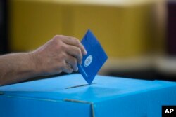 FILE - An Israeli man casts his vote during Israel's general elections in Tel Aviv, Israel, April 9, 2019.