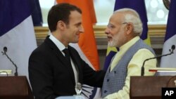 Indian Prime Minister Narendra Modi, right, talks with visiting French President Emmanuel Macron after the signing of several agreements in New Delhi, India, March 10, 2018.