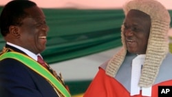 FILE: Zimbabwean President Emmerson Mnangagwa,left, is congratulated by Chief Justice Luke Malaba after taking his oath during his inauguration ceremony at the National Sports Stadium in Harare, Sunday, Aug. 26, 2018.