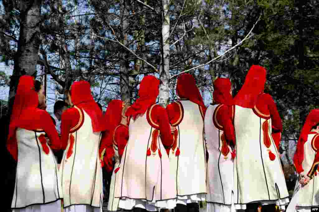 Members of the Kosovar folklore group take part in a ceremony in Pristina to mark the 15th anniversary of the killing of Kosovo Liberation Army (KLA) commander Adem Jashari. Jashari was among 45 members of his family killed by Serb security forces in the vilage of Prekaz some 40 kms west of the Kosovo capital Pristina, sparking a full-blown rebel insurgency.