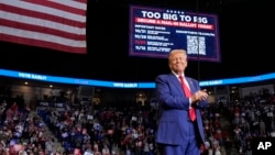 Republican presidential nominee former President Donald Trump smiles at a campaign rally at the Bryce Jordan Center in State College, Pennsylvania, Oct. 26, 2024.