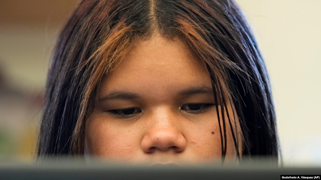 Alisson Ramírez uses a laptop to work on an assignment during science class Wednesday, Aug. 28, 2024, in Aurora, Colorado. (AP Photo/Godofredo A. Vásquez)