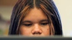 Alisson Ramírez uses a laptop to work on an assignment during science class Wednesday, Aug. 28, 2024, in Aurora, Colorado. (AP Photo/Godofredo A. Vásquez)