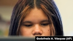 Alisson Ramírez uses a laptop to work on an assignment during science class Wednesday, Aug. 28, 2024, in Aurora, Colorado. (AP Photo/Godofredo A. Vásquez)