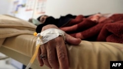 FILE - A Yemeni woman suspected of being infected with cholera receives treatment at a hospital in the capital Sanaa, July 24, 2018. 