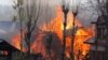 Flames and smoke billow from residential houses after they caught fire during a gunbattle between Indian army soldiers and suspected militants at Kachdoora village in south Kashmir's Shopian district, Apr. 1, 2018.