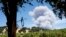 Smoke billows behind a vineyard in Hopland, California, as the River Fire burns, July 30, 2018. 