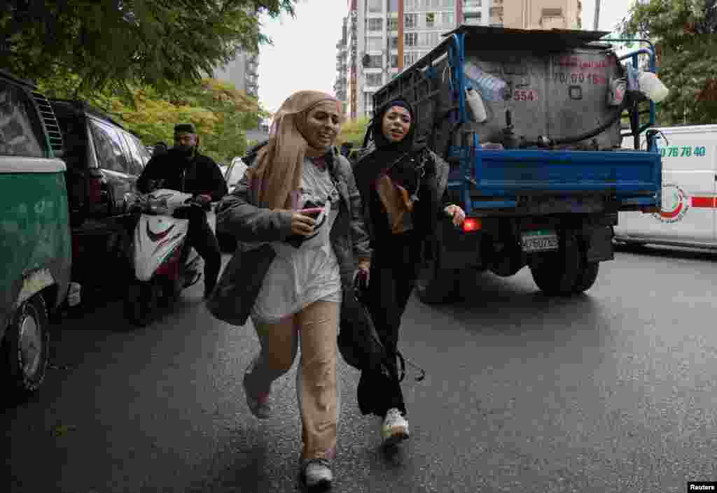 Girls react as they run for cover after an Israeli strike on a building, that according to security sources killed Hezbollah&#39;s media relations chief Mohammad Afif, in Ras Al- Nabaa, Beirut, Lebanon.