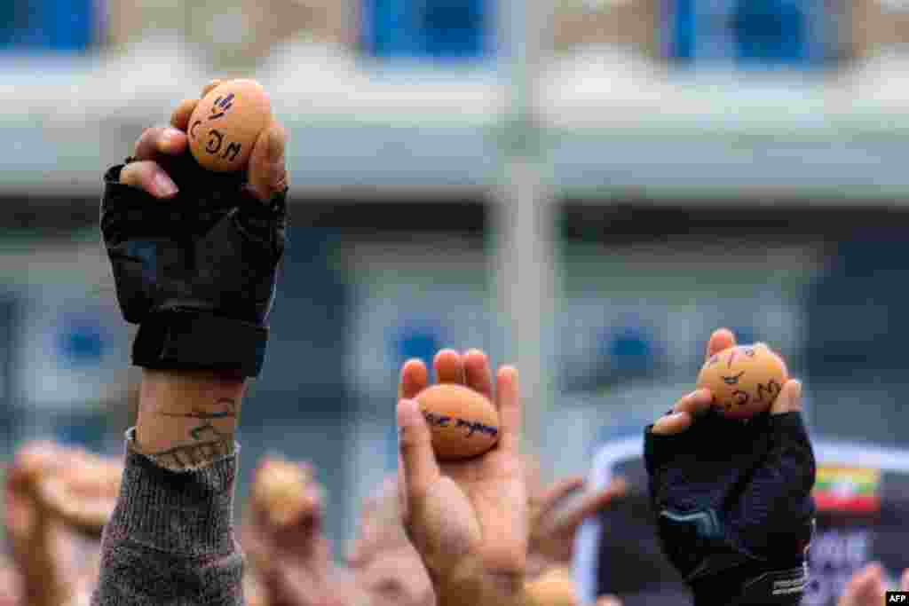 Protesters holding eggs with messages to coincide with Easter Sunday during a demonstration against the military coup in Taunggyi in Myanmar&#39;s Shan state. (Anonymous Source)